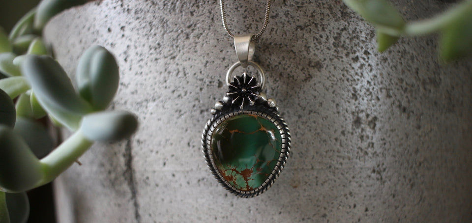 dark green royston pendant set in sterling silver with seed pod